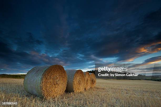 stunning sunset over straw bales - equinox stock pictures, royalty-free photos & images