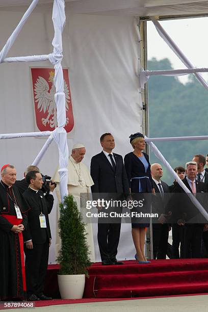 Unidentified Polish bishops listen , Pope Francis, Polish President Andrzej Duda and his wife, First Lady Agata Kornhauser-Duda, stand on a podium at...