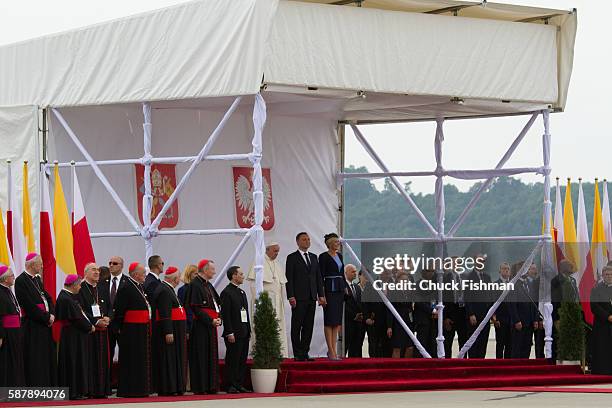 Unidentified Polish bishops listen , Pope Francis, Polish President Andrzej Duda and his wife, First Lady Agata Kornhauser-Duda, stand on a podium at...