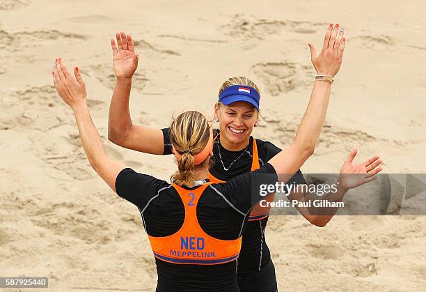 Marleen van Iersel and Madelein Meppelink of the Netherlands celebrate during their women's prelimiary pool F match against Taliqua Clancy and Louise...