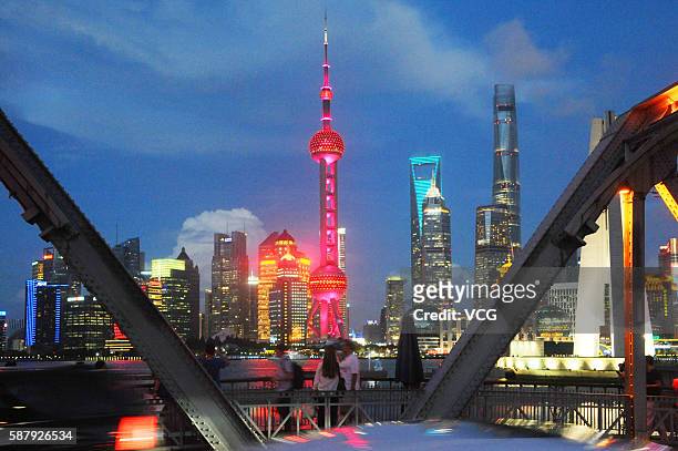 Shanghai's symbolic Oriental Pearl TV Tower lights up in colors of Chinese national flag to cheer for Chinese athletes and congratulate them on their...