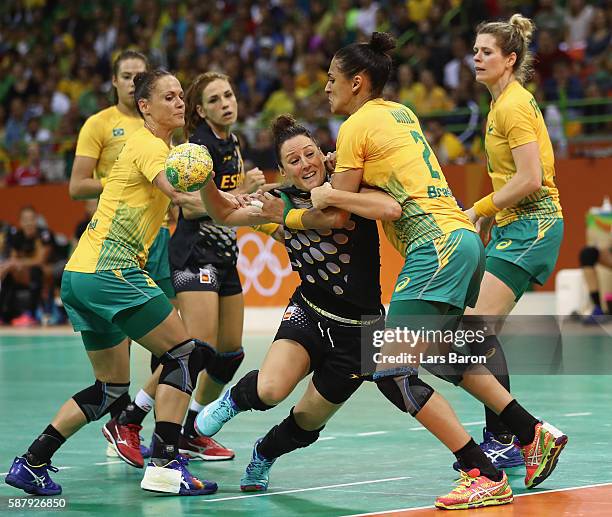 Macarena Diaz Aguilar of Spain is challenged by Daniela Piedade and Fabiana Diniz of Brazil during the Womens Preliminary Group A match between...