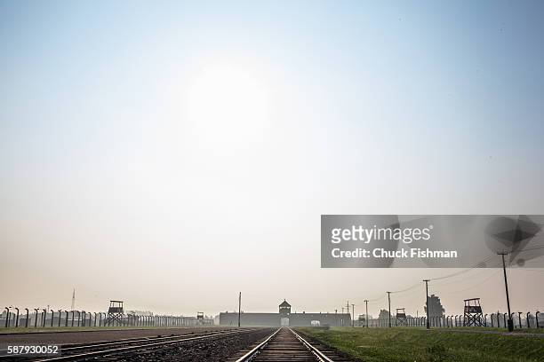 View of train tracks leading to the main gate of the former Auschwitz IIBirkenau concentration camp, now the Auschwitz-Birkenau State Museum,...