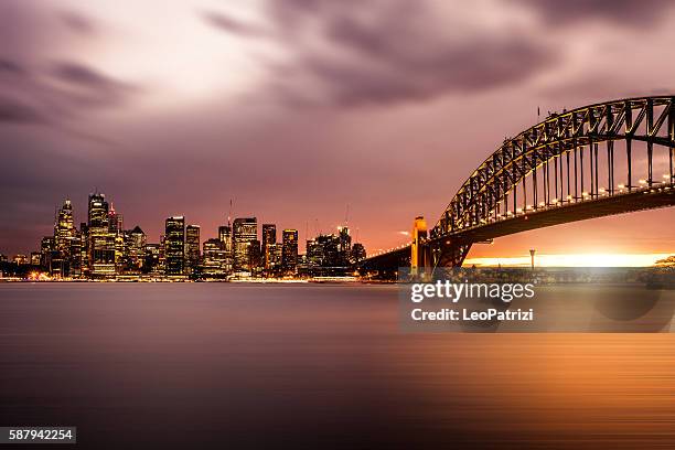 cityscape of sydney downtown and harbor bridge - sydney at dusk stock pictures, royalty-free photos & images