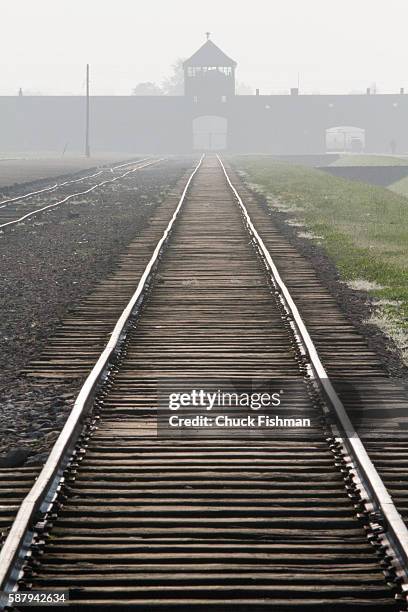 View of train tracks leading to the main gate of the former Auschwitz IIBirkenau concentration camp, now the Auschwitz-Birkenau State Museum,...