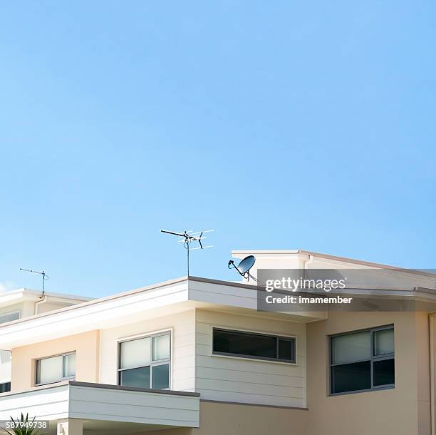 modern contemporary house against blue square background with copy space - satellite dish home stock pictures, royalty-free photos & images