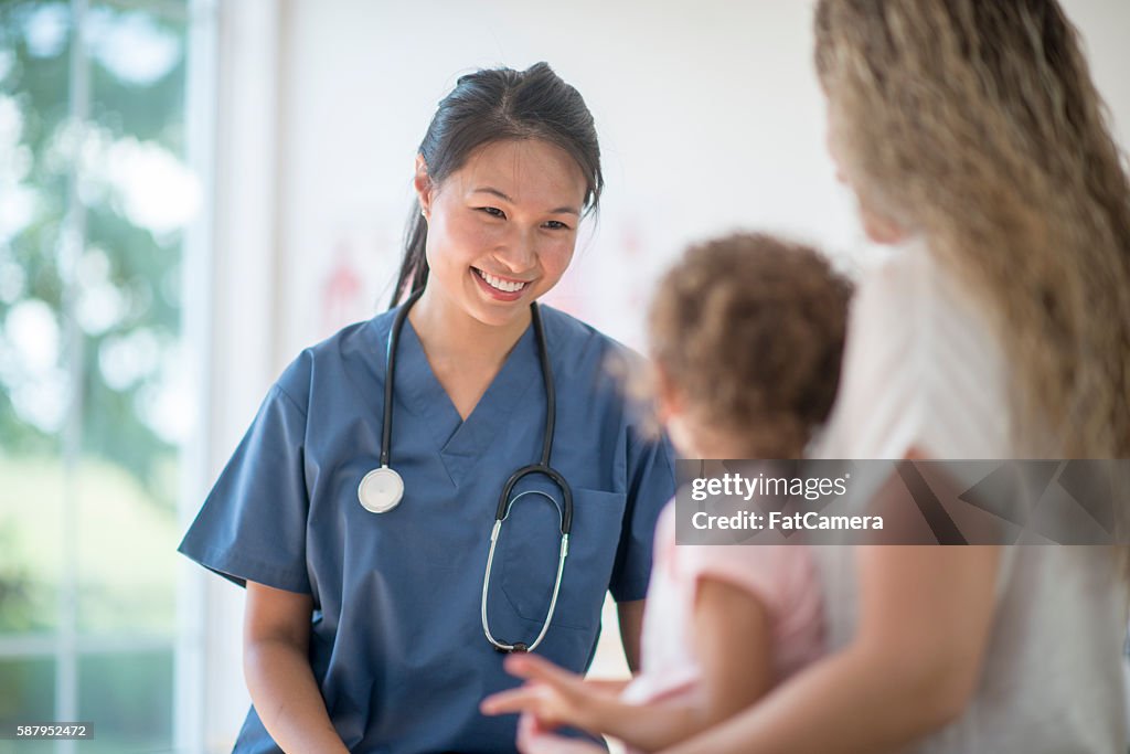 Nurse Speaking to a Mother and Child