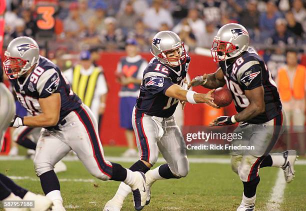 New England Patriots quarterback Tom Brady hands off to Cory Dillon during 3rd quarter NFL football action in the seaon opening game vs. The Oakland...