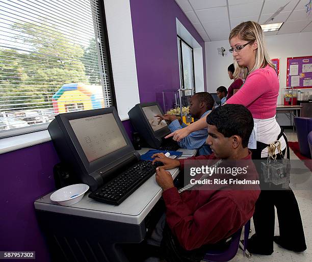 Casey Gallagher helps Adam Nasser and Jefferey Honore, during class at Judge Rotenberg Center in Canton. The Judge Rotenberg Educational Center is a...