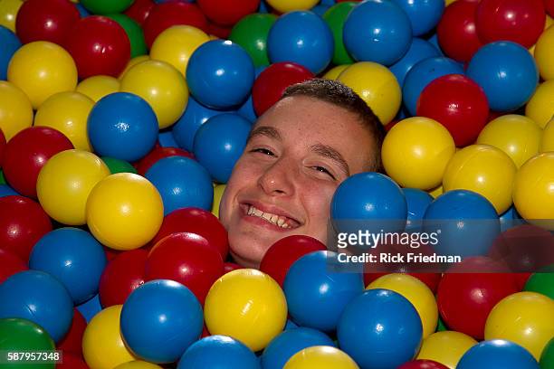 Student plays in a large container of balls in the Game Room as a reward for behaving, at the Judge Rotenberg Center in Canton, MA on September 24,...