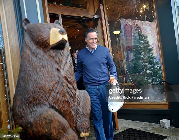 Republican presidential candidate and former MA Governor Mitt Romney walking by a carved bear after shopping for Christmas gifts with his wife wife...