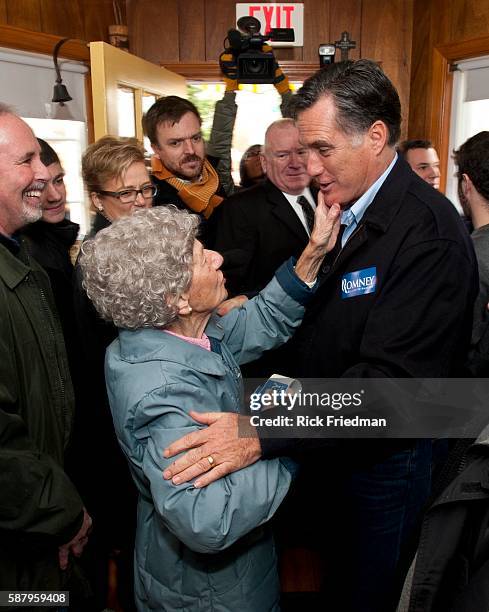 Republican presidential candidate and former MA Governor Mitt Romney hugs a supporter while campaigning at Geno's Chowder & Sandwich shop in...