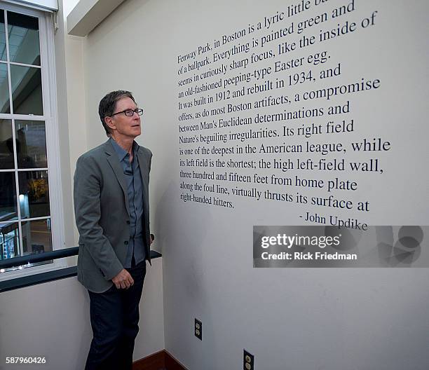 John Henry, principal owner of the Red Sox standing next to a quote from John Updike painted on the wall at Fenway Park in Boston, MA on September...