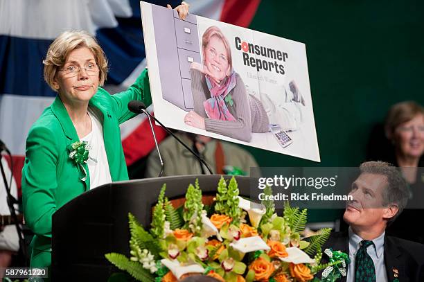 Democratic candidate for US Senate Professor Elizabeth Warren of Harvard Law School holding a mock centerfold of her, to poke fun at Senator Scott...