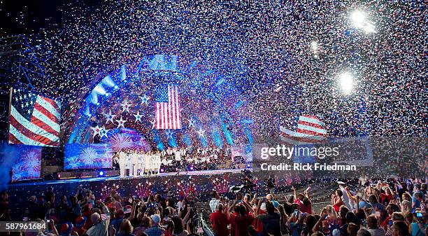 The Boston Pops orchestra performing at the Hatch Shell on the Charles River Esplanade during the dress rehearsal for the July 4th concert in Boston,...