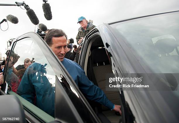 Republican presidential candidate and former Senator Rick Santorum getting into the pickup truck he was traveling after campaigning at the Tilt'n...