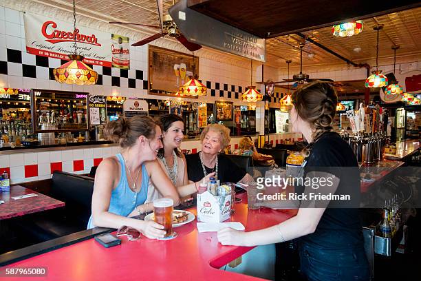 Helen Metros, an 83 year old waitress at Charlie's Kitchen in Harvard Sq, Cambridge, MA on August 21, 2013 with Alix Easton of Brighton and Nina...