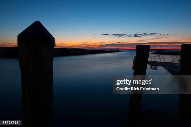 Sunset over Menemsha Sound in the town of Chilmark on Martha's Vineyard, MA over looking beach in the town of Aquinnah, formerly known at Gay Head on...