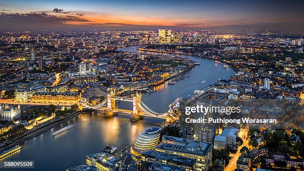 london skyline with tower bridge at twilight - aerial view london stock-fotos und bilder