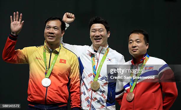 Silver medalist Xuan Vinh Hoang of Vietnam, gold medalist Jongoh Jin of Korea, and bronze medalist Song Guk Kim of China pose on the podium following...