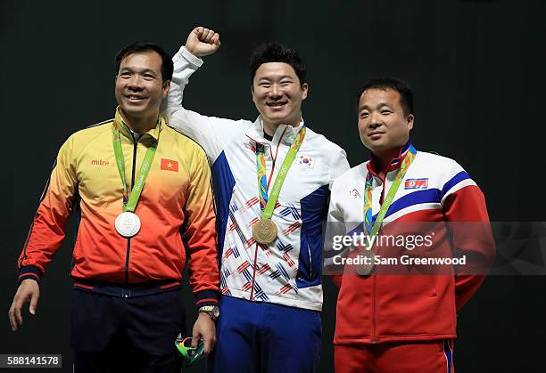 Silver medalist Xuan Vinh Hoang of Vietnam, gold medalist Jongoh Jin of Korea, and bronze medalist Song Guk Kim of China pose on the podium following...