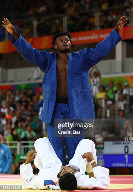 Popole Misenga of the Refugee Olympic Team celebrates after defeating Avtar Singh of India during a Men's -90kg bout on Day 5 of the Rio 2016 Olympic...