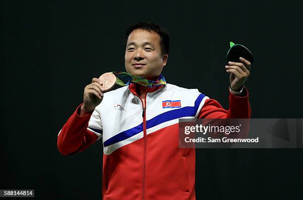 Bronze medalist Song Guk Kim of China poses on the podium following the 50m pistol event on Day 5 of the Rio 2016 Olympic Games at the Olympic...