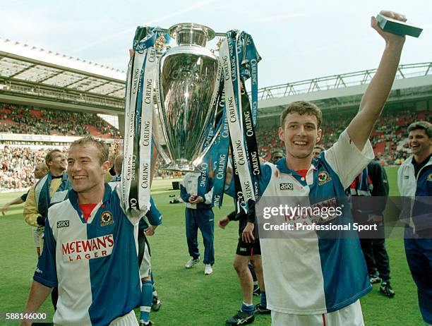 Blackburn Rovers strikers Chris Sutton and Alan Shearer celebrating with the FA Premier League Championship trophy following their match against...