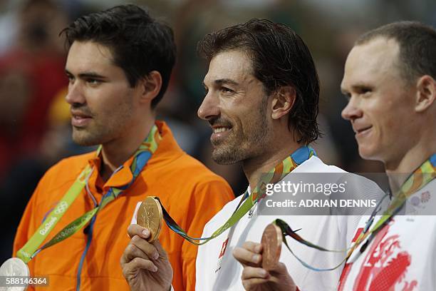 Silver medallist Netherlands' Tom Dumoulin, gold medallist Switzerland's Fabian Cancellara and bronze medallist Britain's Christopher Froome pose on...