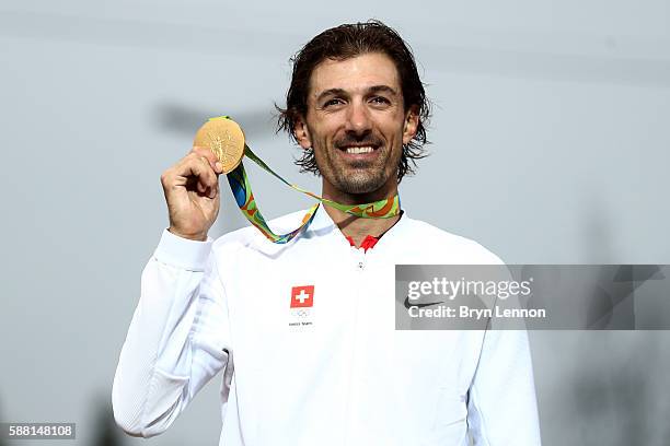 Gold medalist Fabian Cancellara of Switzerland poses for photographs with his medal on the podium at the medal ceremony for the Cycling Road Men's...