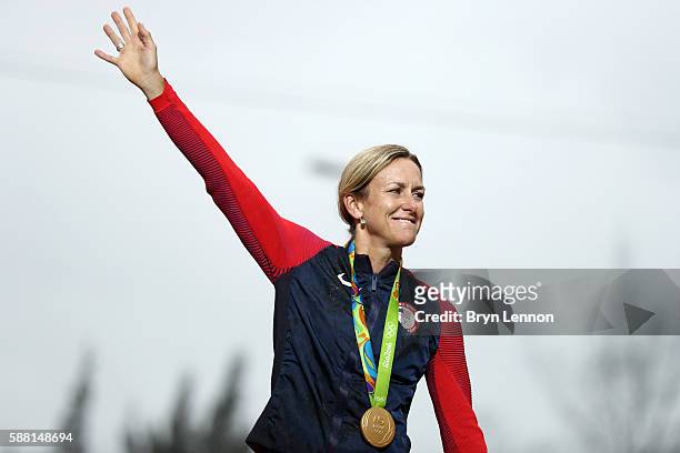 Gold medalist Kristin Armstrong of the United States waves on the podium at the medal ceremony for the Cycling Road Women's Individual Time Trial on...