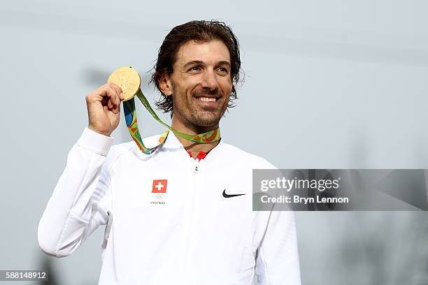 Gold medalist Fabian Cancellara of Switzerland poses for photographs with his medal on the podium at the medal ceremony for the Cycling Road Men's...