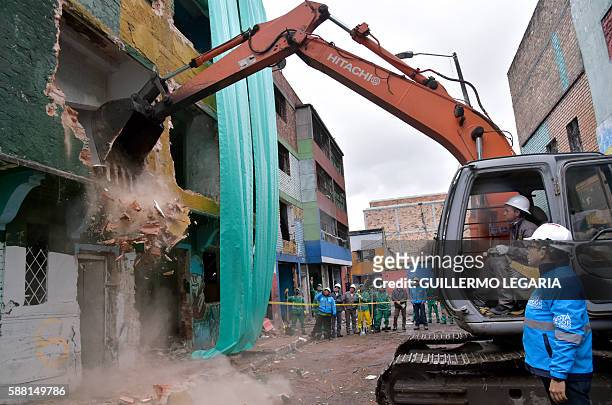 Municipal employees prepare to clean during demolition works at a section known as The Bronx -which until a few months ago was plagued by rampant...