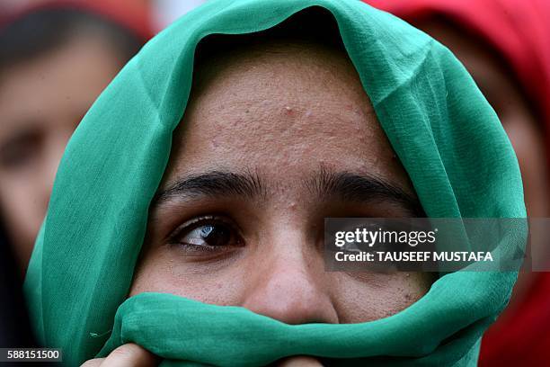 Kashmiri woman cries during a protest against a police officer who shot dead a local teenager allegedly inside his house compound during the ongoing...
