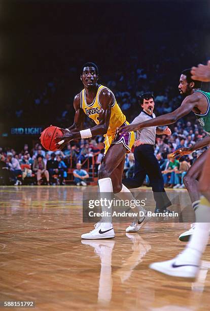 Michael Cooper of the Los Angeles Lakers handles the ball against the Dallas Mavericks during a game circa 1987 at The Forum in Los Angeles,...