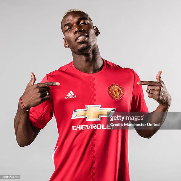 Paul Pogba of Manchester United poses after signing for the club at Aon Training Complex on August 8, 2016 in Manchester, England.