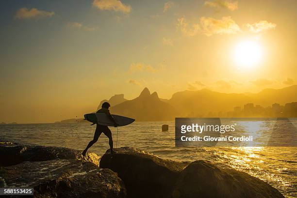 surfer at arpoador, rio de janeiro. - arpoador beach stock pictures, royalty-free photos & images