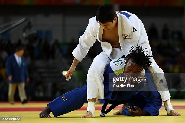 Donghan Gwak of Korea competes against Popole Misenga of the Refugee Olympic Team during a Men's -90kg bout on Day 5 of the Rio 2016 Olympic Games at...