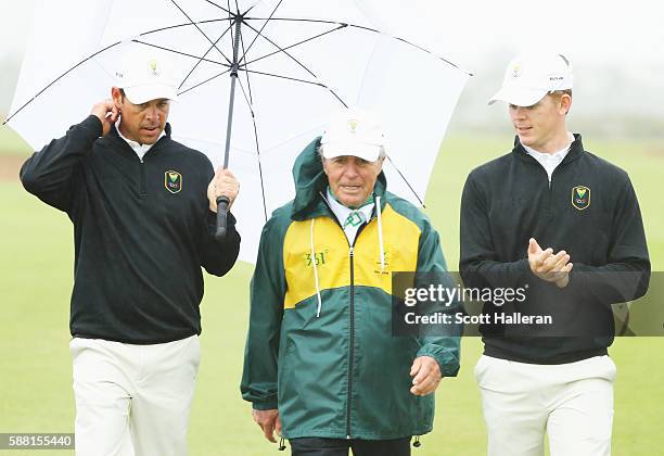 Jaco van Zyl and Brandon Stone of South Africa walk with team leader Gary Player during a practice round on Day 4 of the Rio 2016 Olympic Games at...