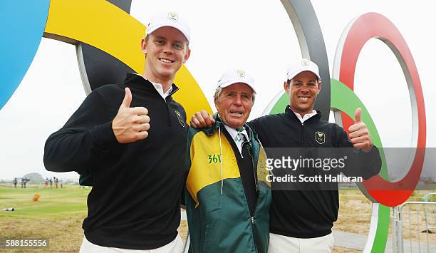 Brandon Stone and Jaco van Zyl of South Africa pose with team leader Gary Player during a practice round on Day 4 of the Rio 2016 Olympic Games at...