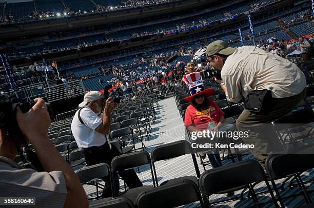 Photographers surround a delegate at the Democratic Presidential candidate before Sen. Barack Obama speaks at the Democratic National Convention at...