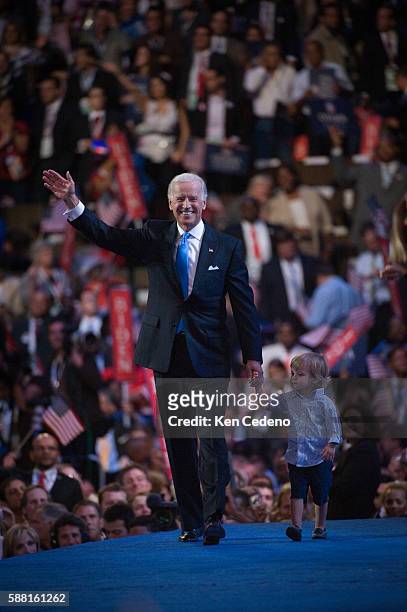 Democratic vice-presidential nominee Joe Biden walks across the stage with his grandson after accepting his nomination at the Democratic National...