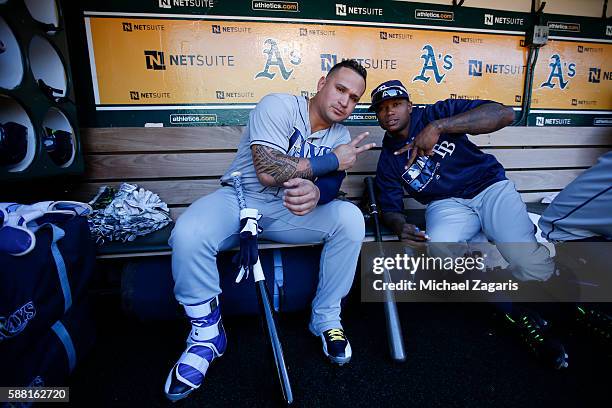 Oswaldo Arcia and Tim Beckham of the Tampa Bay Rays relax in the dugout prior to the game against the Oakland Athletics at the Oakland Coliseum on...