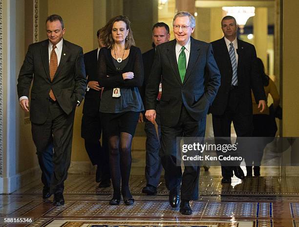 Minority Leader Senator Mitch McConnell walks to the Senate floor with his staff to consider a possible deal to prevent the 'fiscal cliff', on...