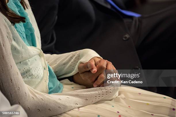 Principal Deputy Solicitor General of the United States, Srikanth Srinivasan hold the hand of one of his twin children, Maya Srinivasan, 11 before...