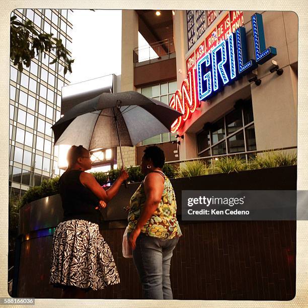 Two women chat in front of the CNN Grill leading into the Democratic National Convention in Charlotte, NC September 1, 2012. Photo Ken Cedeno
