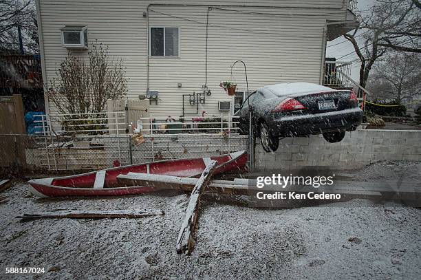 Car stuck on a brick wall sits next to a home in the Midland Beach neighborhood of Staten Island borough of New York City that was destroyed by...