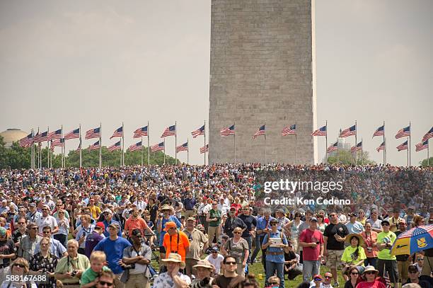 Thousands gather on the National Mall during an array of other World War II aircraft ever assembled to fly over the National Mall celebrating the...