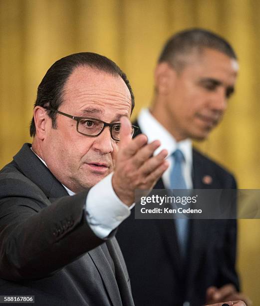 French President Francois Hollande answers reporters question during a news conference with U.S. President Barack Obama in the East Room after a...