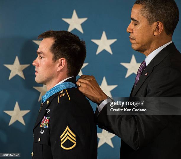 President Barack Obama awards Clinton Romesha, a former active duty Army Staff Sergeant, the Medal of Honor for conspicuous gallantry in the East...